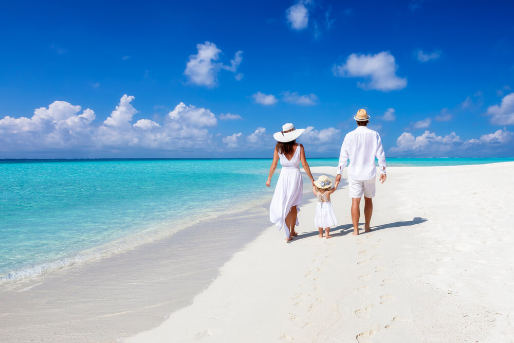 A family walking on the beach in Maldives